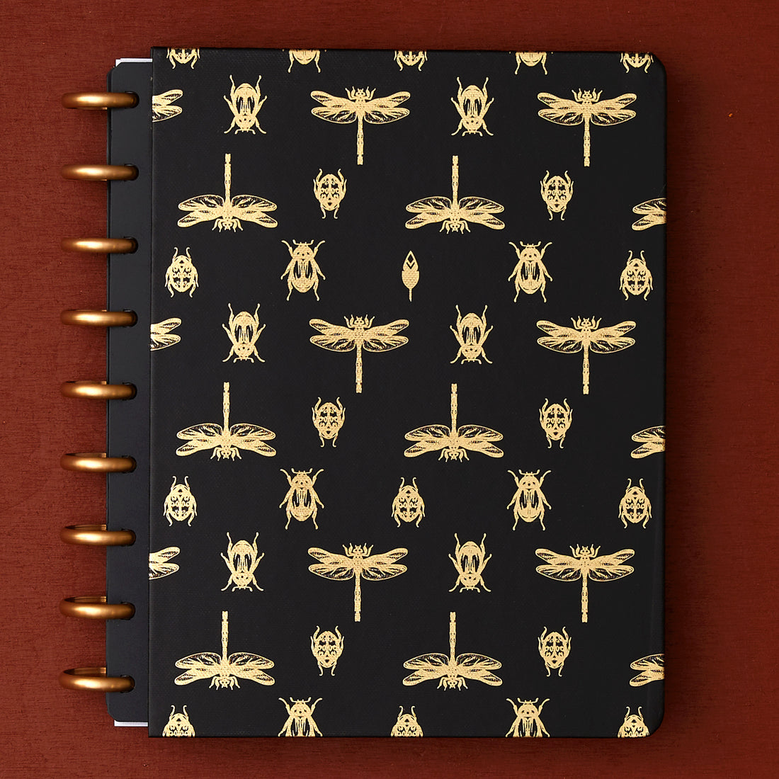 7x9 cover with gold foil beetles and fireflies on a black background. 