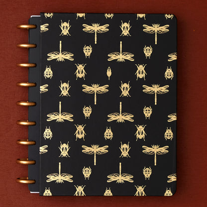 7x9 cover with gold foil beetles and fireflies on a black background. 