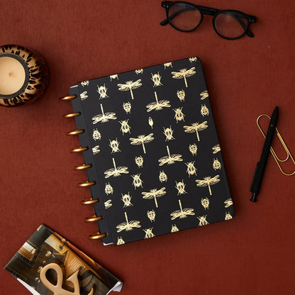 7x9 cover with gold foil beetles and fireflies on a black background. 