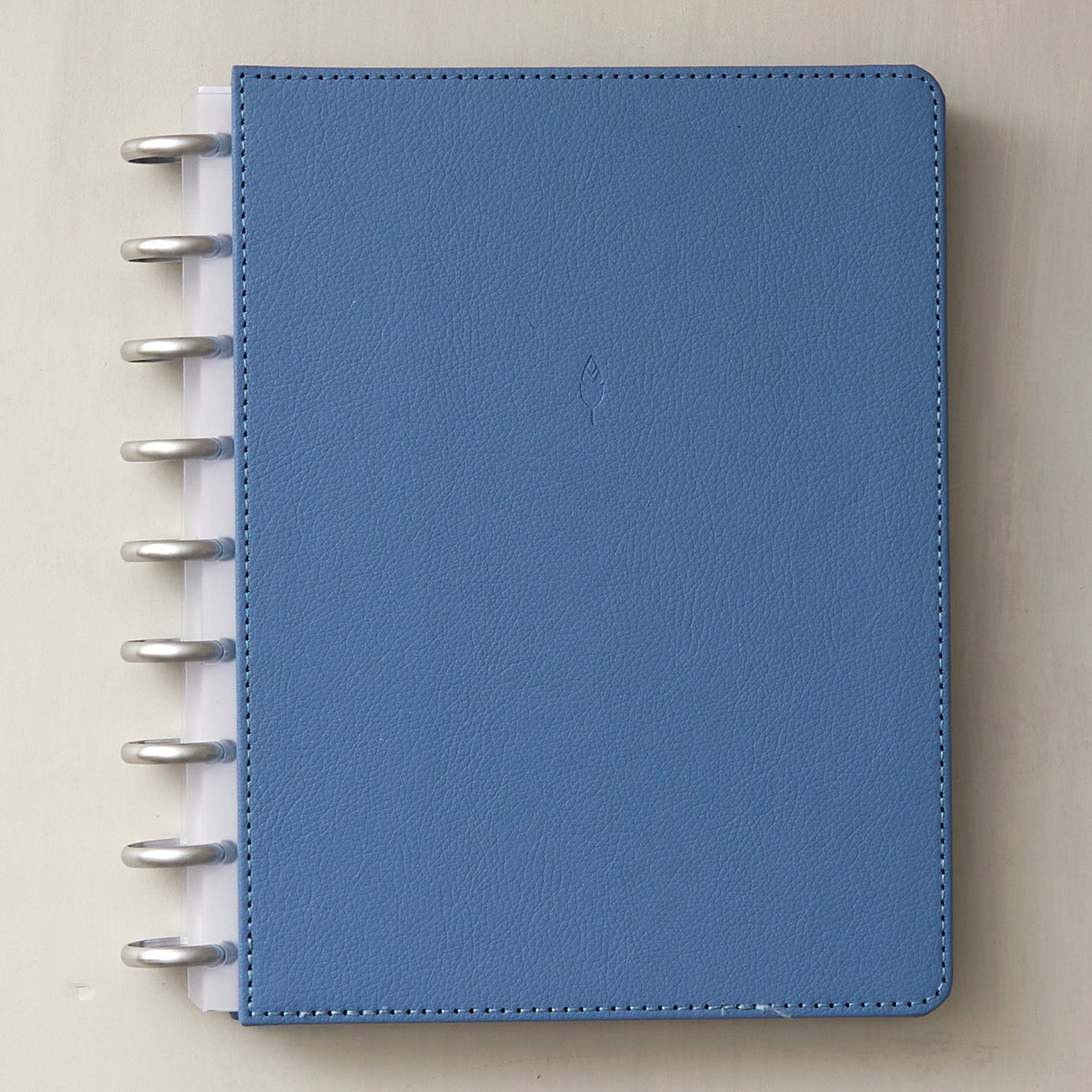 7x9 glacial blue front cover in faux vegan leather with silver discs and clear-white binding