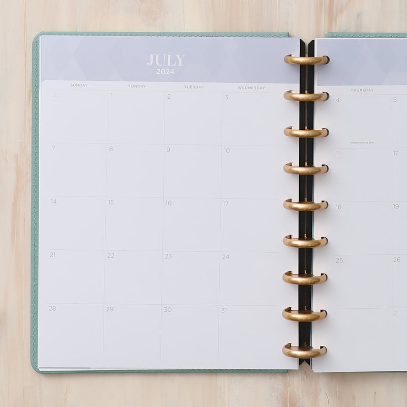 2024-2025 monthly planner featuring a monthly spread with top 5 to do's, lined notes, daily blocks and reference calendars.