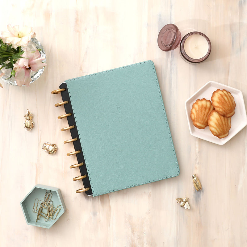 2024-2025 monthly inkwell press planner in 7x9 planner size featuring a rio green vegan leather cover, monthly planning, and premium gold discs