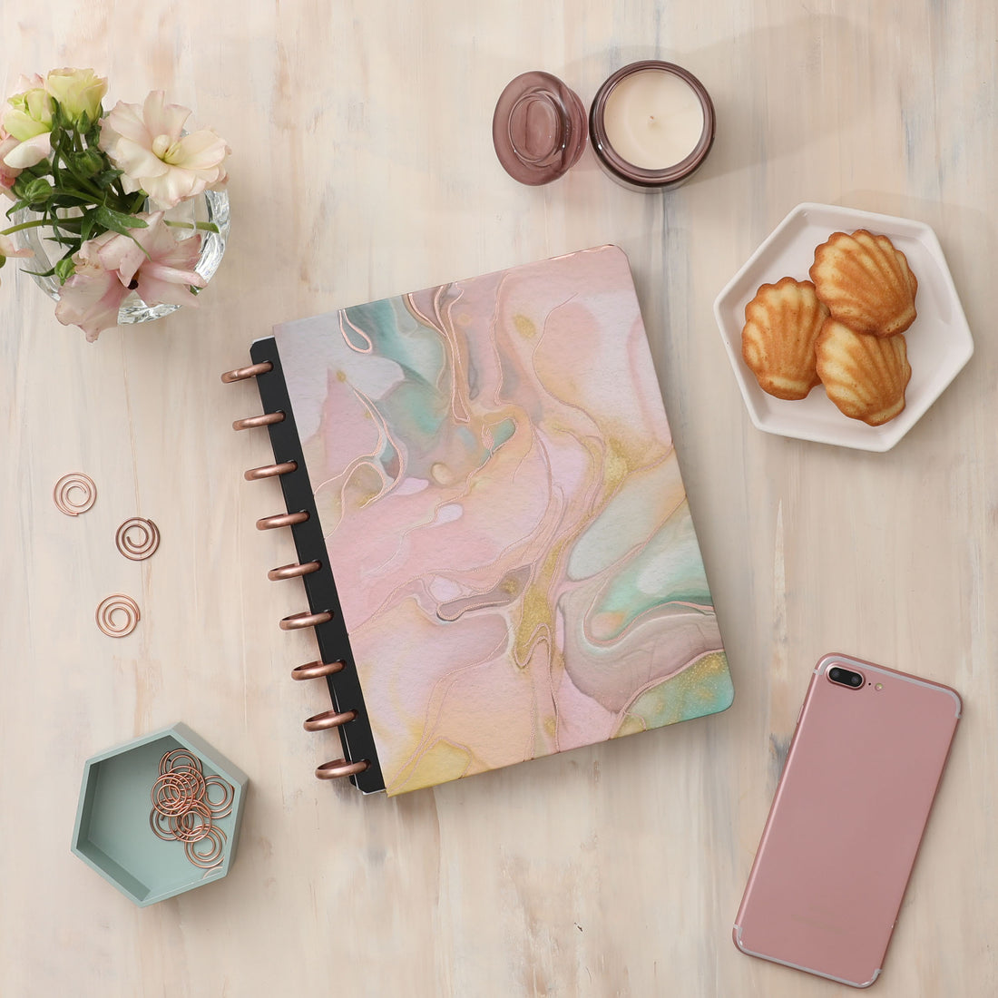 An alcohol ink design in shades of terracotta and pink is the featured hard cover on this inkwell press planner system with rose gold discs