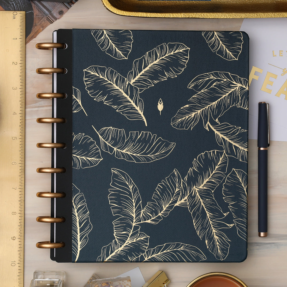 golden embossed quills on a dark blue/green back ground cover for this inkwell press planner