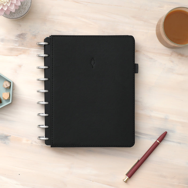 2023-2024 monthly planner bundle, featuring a customer favorites like a black faux leather cover, triple pocket cover, premium silver discs, pen loop, bookmark, lined notes, and dot notes!